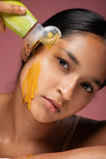 Indian young adult woman applying Skintuition Cosmetics' Amla & Curcumin face cleanser for oily and acne-prone skin